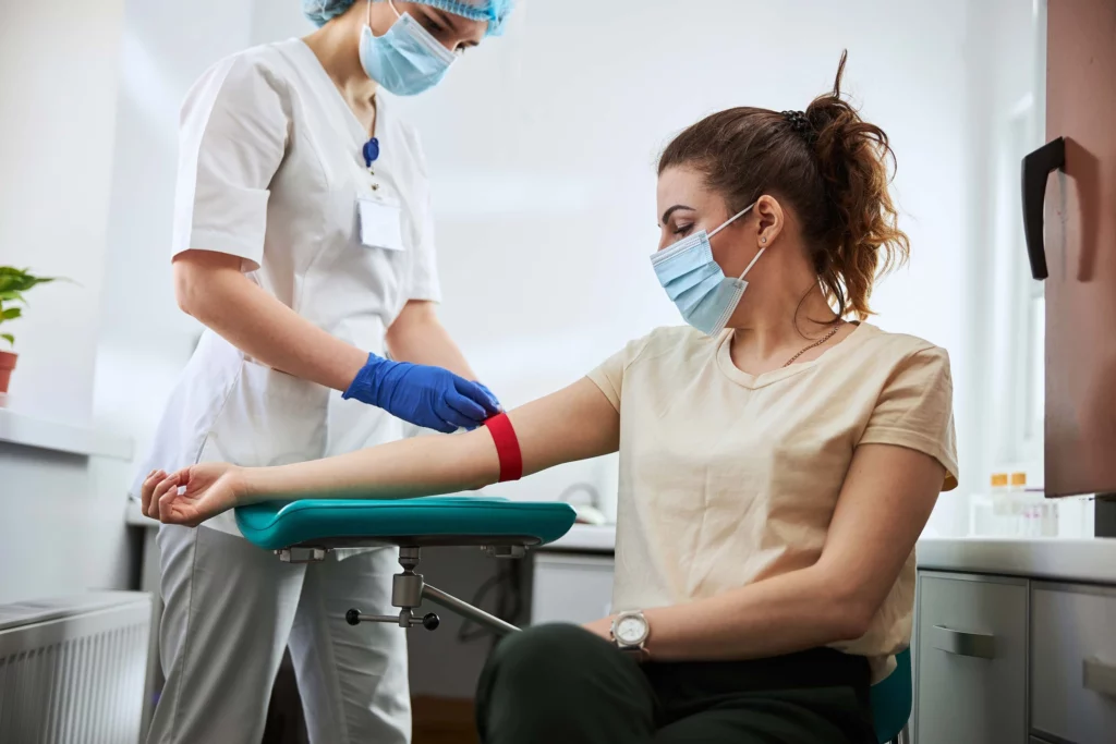 Phlebotomist preparing to take blood from a patient